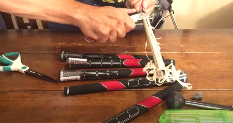 Simply lay the hook beneath the club and gradually slide it down until you've made an incision about halfway down the grip